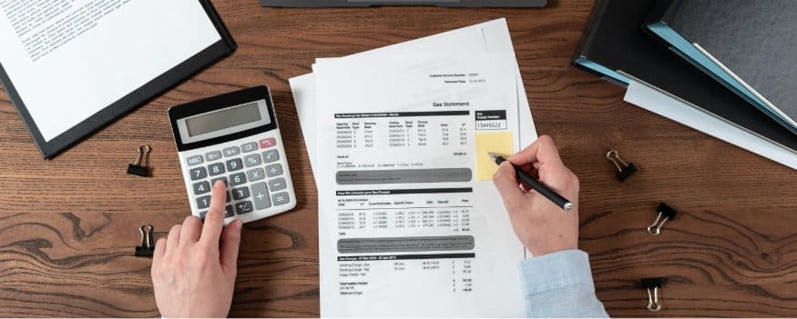 Uma pessoa fazendo cálculos para determinar o ponto de equilíbrio contábil.
