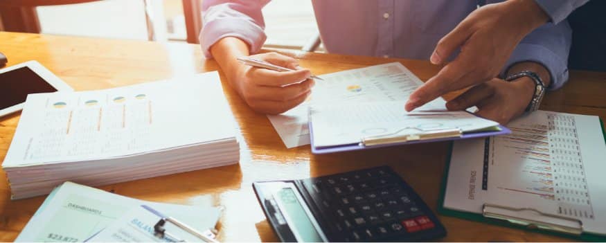 Duas pessoas analisando gráicos referente as contas da empresa.