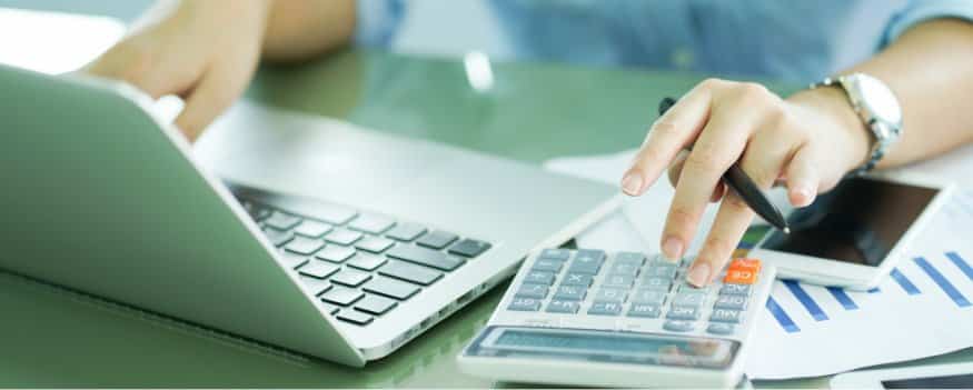 Uma mulher fazendo cálculos e analisando como fazer a formação de preço.