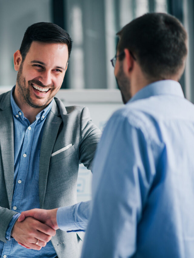 Portrait of cheerful young manager handshake with new employee.